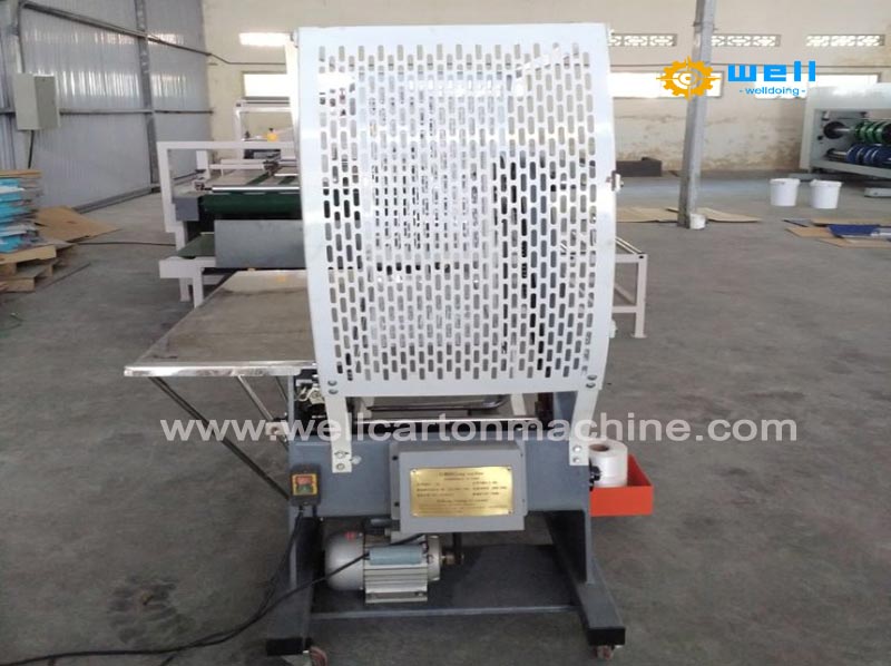 Corrugated carton tying machine