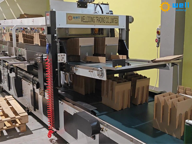 Automatic cardboard carton partition assembly machine